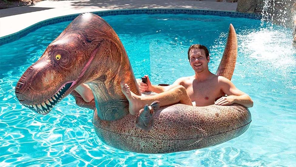Met deze opblaasbare T-rex van PoolCandy ben je de apex predator van het zwembad