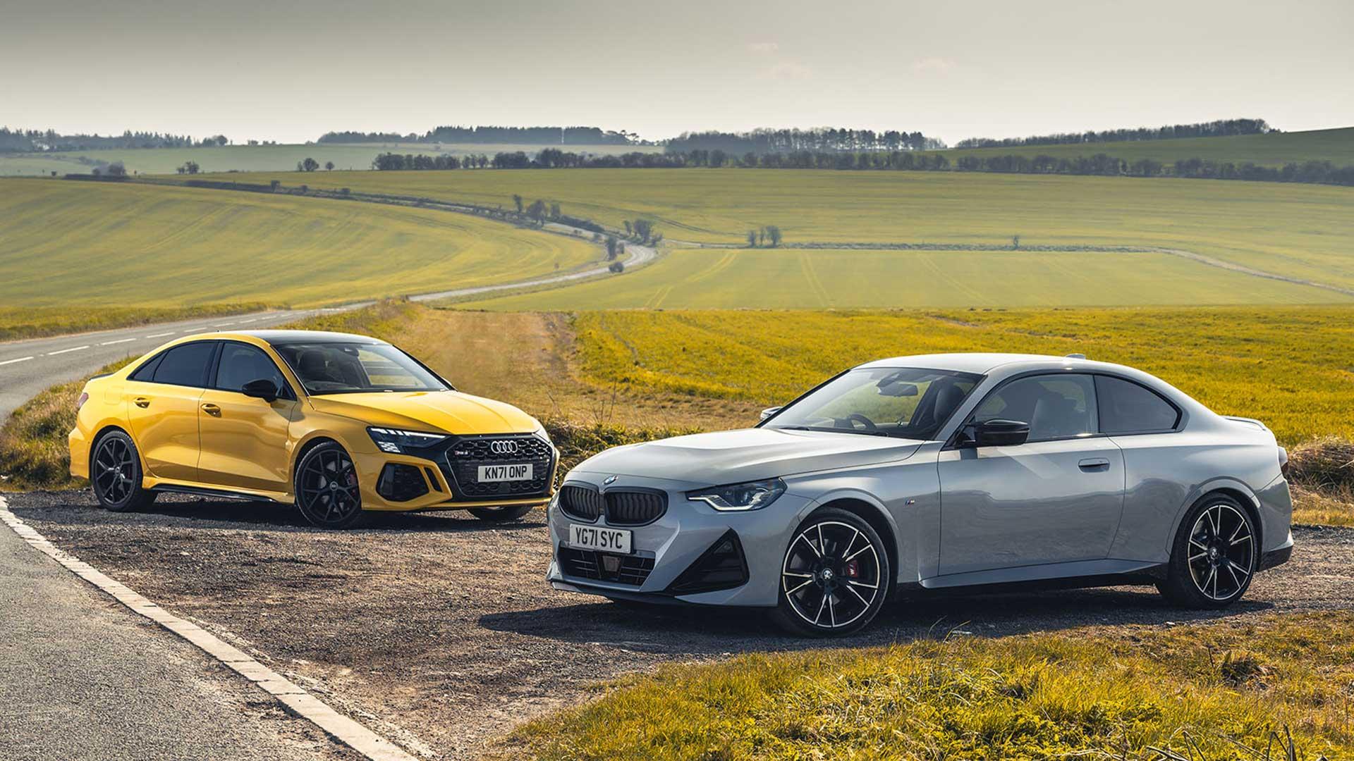 Audi RS 3 Limousine BMW M240i xDrive one behind the other in the field