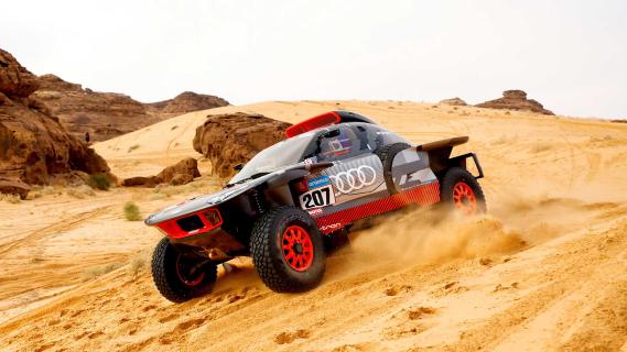 Carlos Sainz Sr Dakar-rally 2023 in de Audi RS Q e-tron rijdend op een duin