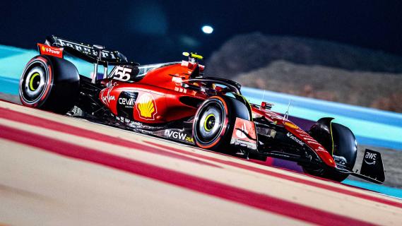 GP van Bahrein 2023 Carlos Sainz rijdend in het donker schuin voor