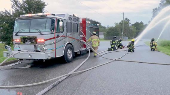 Elektrische brandweerauto E-One schuin voor blussen