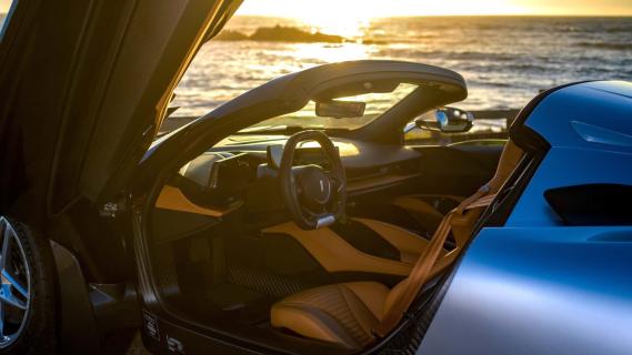 Pininfarina Battista Targamerica zilvergrijs zee zonsondergang interieur bruin