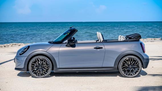 Mini Cooper Cabrio (F67) blauw (2024) zijkant links dak open zon