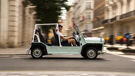 Moke International electric Moke groen zijkant rechts door stad