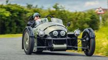 Morgan Super 3 rijdend op een weg schuin voor door een bocht